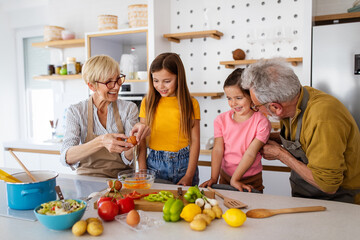 Happy grandparents having fun times with children at home