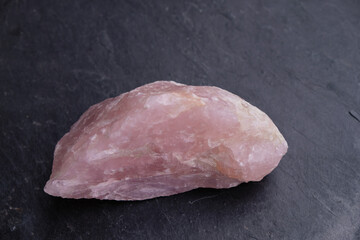 Pink quartz. Mineral. The stone is used in magic. Gray natural slate.