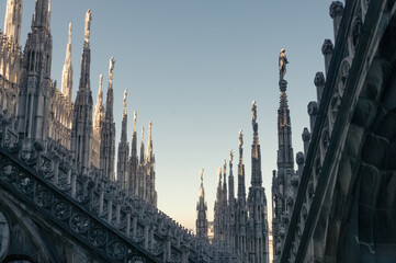 Fototapeta na wymiar Sculptures on the towers of the Duomo Cathedral in Milan