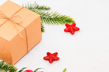 Christmas decor composition white background.Christmas gift box, pine cones, fir branches and star on white background. Flat lay,top view,copy space.