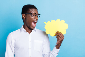 Photo of impressed funky dark skin man wear white shirt spectacles holding mind cloud empty space isolated blue color background