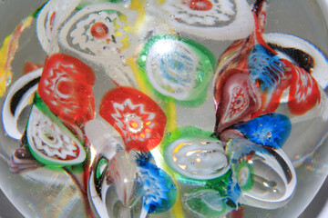 Vibrant Abstract Glass Swirls and Bubbles from a Paperweight with Lines and Colours