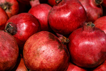 Fototapeta na wymiar Pomegranate background pattern. Fresh organic texture background of many pomegranate fruits.