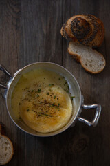 Tomino grilled Italian cheese with sliced bread on wooden table background