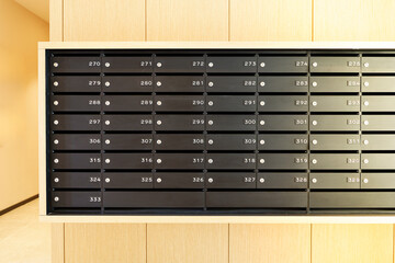 Mailboxes for letters and correspondence. Modern black mailboxes with numbers in the lobby of a residential or office building