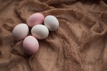 Pink and white Easter eggs. Painted Easter eggs on brown background