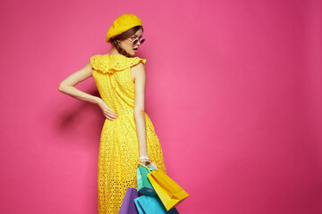 glamorous woman with multicolored bags posing isolated background