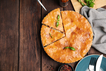 Delicious meat pie served on wooden table, flat lay. Space for text