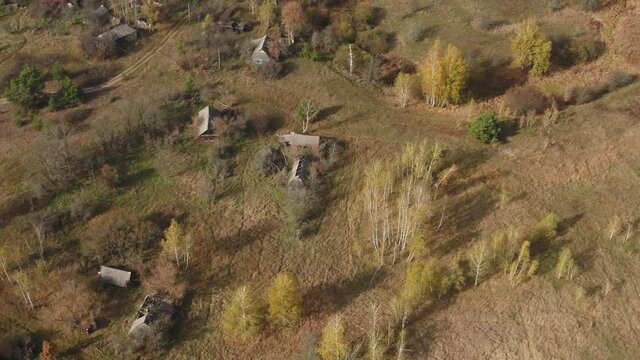 The abandoned village of Rudnya-Veresnya after the accident at the Chernobyl nuclear power plant. The destroyed houses of the villagers. Aerial. Autumn