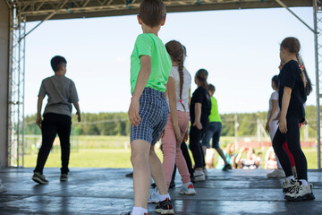 Children on stage. Dance lesson.Children of junior classes. School activity.