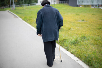 Pensioner in Moscow. An elderly woman in Russia. A man with a walking stick.