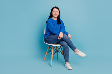 Full length profile side photo of young cheerful girl happy positive smile sit chair comfort enjoy...