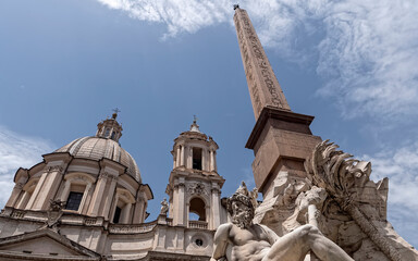 Fototapeta na wymiar the famous four rivers fountain with the Egyptian obelisk and baroque church in piazza Navona, Rome Italy