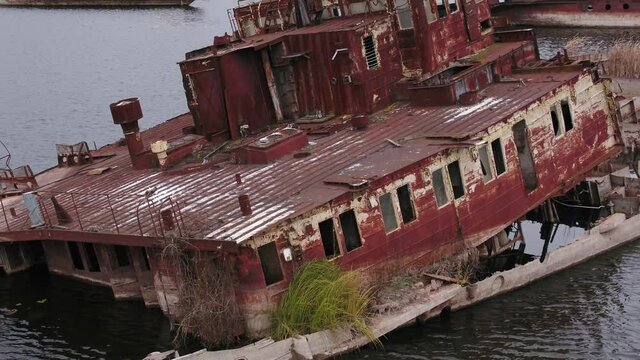 Aerial view of boat, ship and barge graveyard on the Pripyat river abandoned after Chernobyl disaster. Autumn.