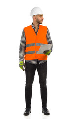 Engineer in orange reflective waistcoat and white helmet is standing with documents and looking at...