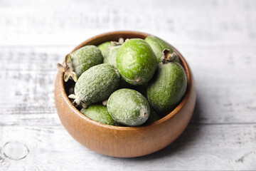 Feijoa fruits or pineapple guava in bowl on wooden table