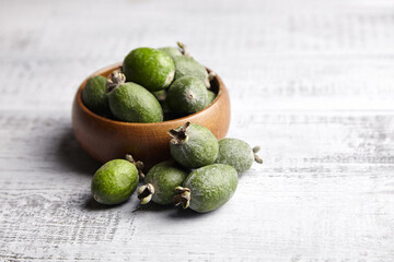 Feijoa fruits or pineapple guava in bowl on wooden table
