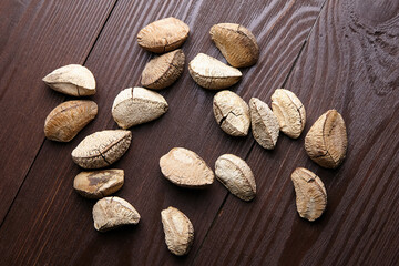 Brazil nuts or Bertholletia excelsa seeds on wooden table