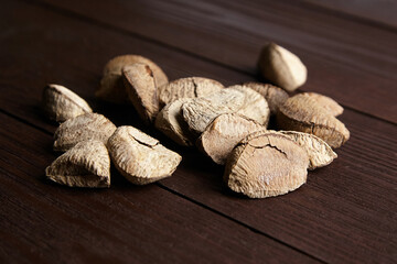 Brazil nuts or Bertholletia excelsa seeds on wooden table