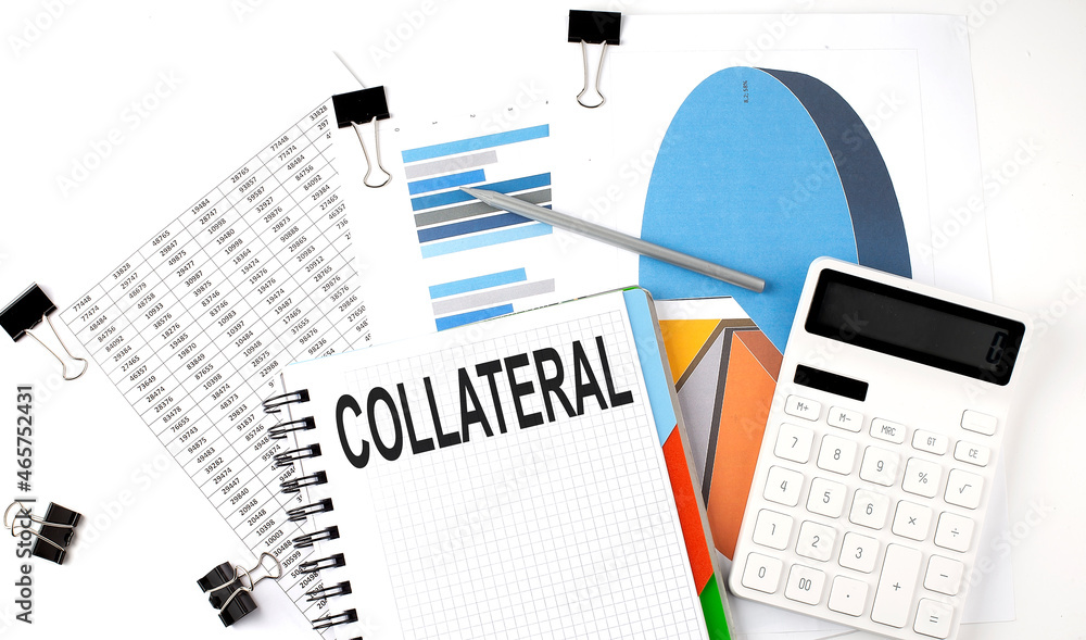 Aufkleber text collateral on a notebook on the diagram and charts with calculator and pen