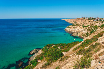 Naklejka na ściany i meble Panoramic sea view on Cape Fiolent in Crimea. A famous place for tourists on the Black Sea coast with azure water