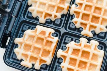 Homemade waffles. Electric waffle maker. 