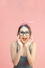 Beautiful girl with pretty smile in pin up style on pink background