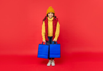 black friday discount. seasonal christmas sales. happy teen girl in with shopping bag.