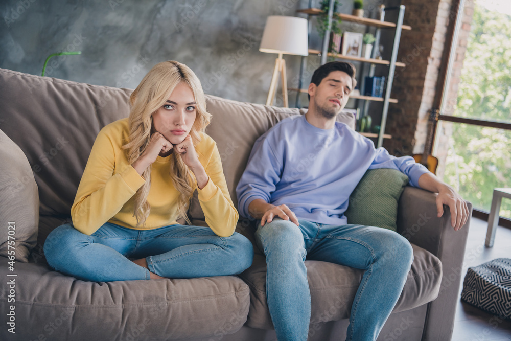 Poster photo of young couple unhappy sad negative disagreement conflict moody bad problem bored sit couch i