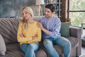 Photo of beautiful unhappy young lovers dressed casual clothes sitting sofa having relationship...