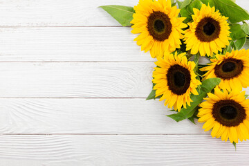 Sunflowers on white wooden background. Valentine's, womens, mothers day, easter, birthday or wedding, autumn holiday flat lay. Top view. Copy space.