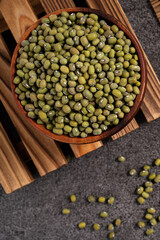 Raw mung bean on wooden table background.