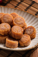 Dried scallop on wooden table.