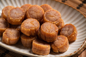 Dried scallop on wooden table.