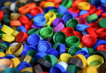 Plastic bottle caps background. Cap material is recyclable.Remove lids from plastic bottles before recycling them. Recycling collection and processing plastic bottle caps