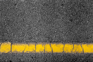 Fototapeta premium top view of a black dark road street tarmac surface background texture with copy space yellow line marking