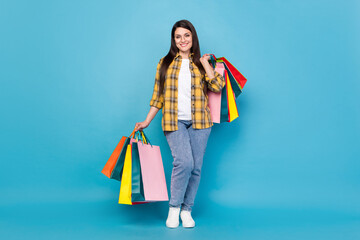 Full length body size view of attractive cheerful girl holding new things bags bargain isolated...
