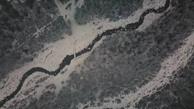 Storm, snowfall in a huge in the valley of the Aktru River, Altai mountains. Cloudy weather, wildlife, winter forest, flowing mountain river in the valley of the Chuya River and Aktru Altai Republic