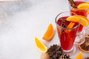 Mugs of mulled wine. Ingredients for a cocktail. Hot winter drinks based on sparkling wine.