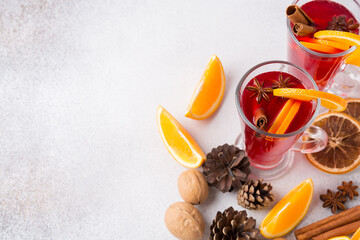 Mugs of mulled wine. Ingredients for a cocktail. Hot winter drinks based on sparkling wine.