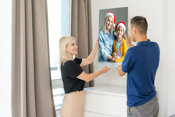 a man holding a photo canvas with a picture of christmas