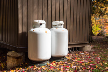 Propane cylinders outside a metal hut in a park in autumn
