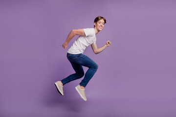 Fototapeta na wymiar Full size profile side photo of young man good mood runner jumper sale isolated on violet color background