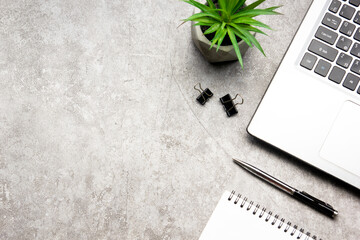 White desk office with laptop, smartphone and other work supplies with cup of coffee. Top view with...
