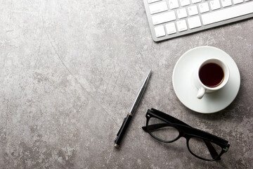 White desk office with laptop, smartphone and other work supplies with cup of coffee. Top view with...