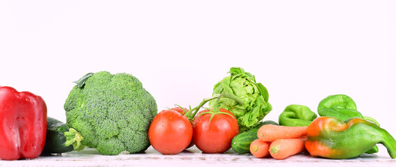 Large elongated format. Healthy food, fresh assorted vegetables and tomatoes, isolated, on white background and copy space.	