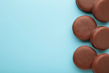 Choco pie chocolate coated snacks on blue background with copy space.