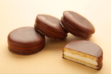 Obraz na płótnie Canvas Choco pie chocolate coated snacks on beige background.