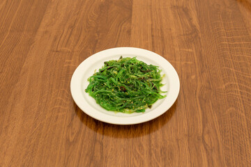 Japanese wakame seaweed salad with sesame and Asian sauce.
