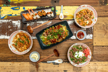 set of Asian food dishes and condiments, noodles, soy sauce, sesame, ramen, nigiri sushi, spoons, lemon, wasabi, pork and chicken